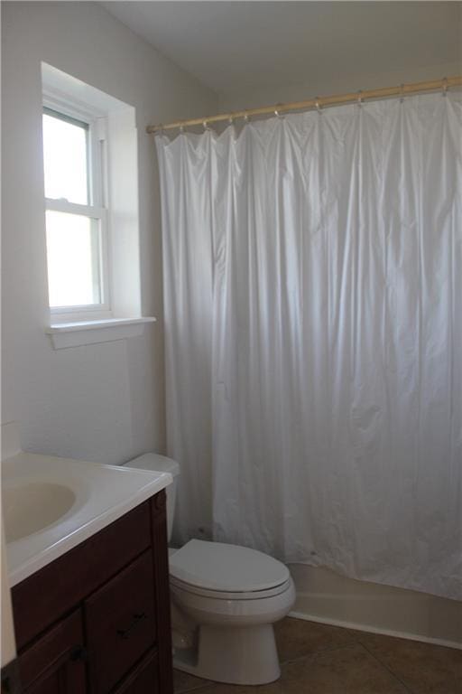 bathroom with tile patterned floors, vanity, and toilet