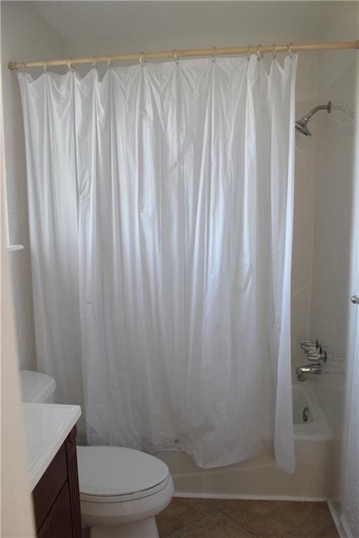 full bathroom with shower / bath combo with shower curtain, tile patterned flooring, vanity, and toilet