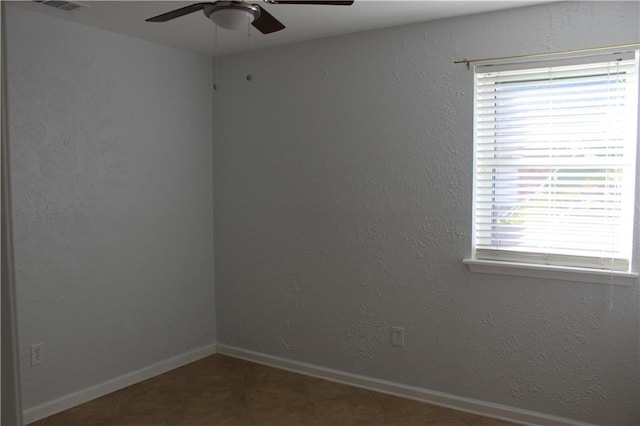 unfurnished room with ceiling fan and a wealth of natural light