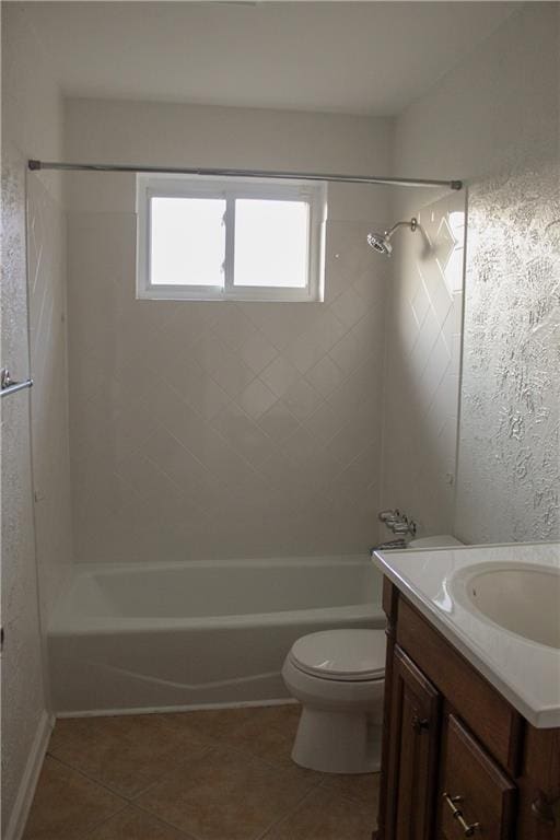 full bathroom featuring tile patterned flooring, toilet, and tiled shower / bath