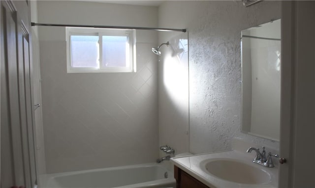 bathroom with vanity and tiled shower / bath combo