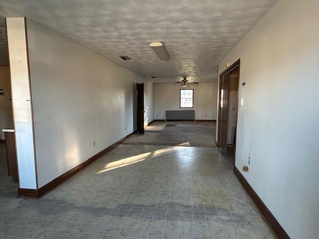 corridor featuring a textured ceiling