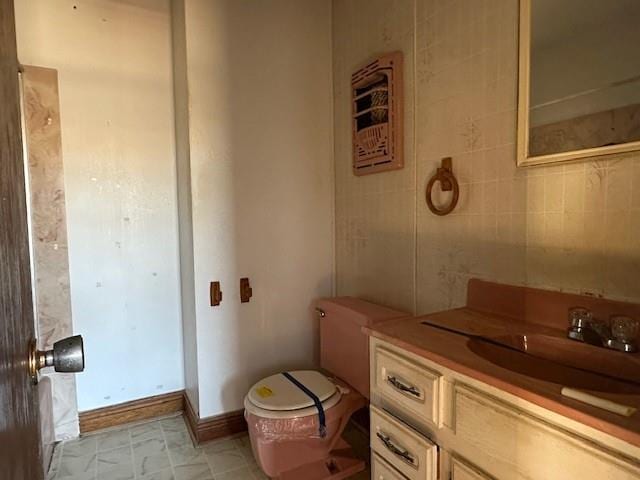 bathroom featuring vanity and tile walls