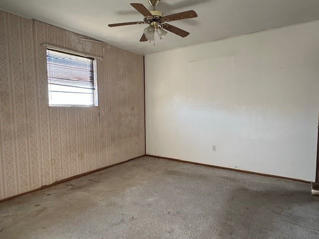 carpeted spare room with ceiling fan