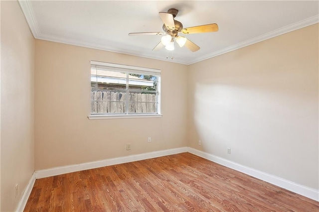 spare room featuring wood-type flooring, ceiling fan, and crown molding