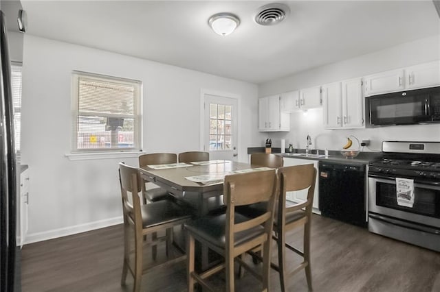 kitchen featuring white cabinets, sink, dark hardwood / wood-style floors, and black appliances