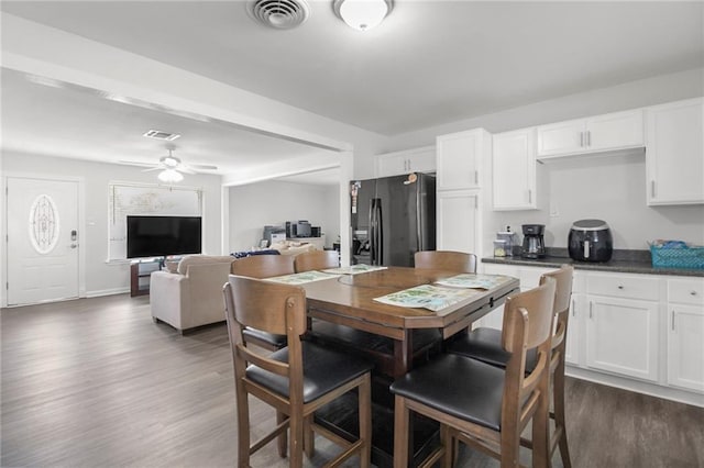 dining room featuring ceiling fan and dark wood-type flooring