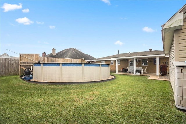 view of yard featuring a fenced in pool and a patio