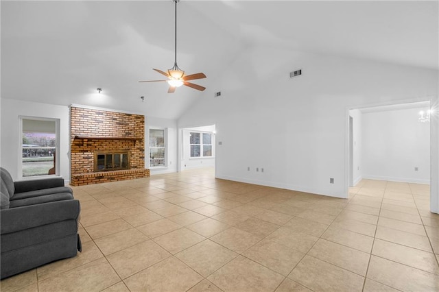 34222 Laurent Rd, Slidell, LA 70460 - unfurnished living room with light tile patterned flooring, ceiling fan, high vaulted ceiling, a fireplace, and healthy amount of natural light