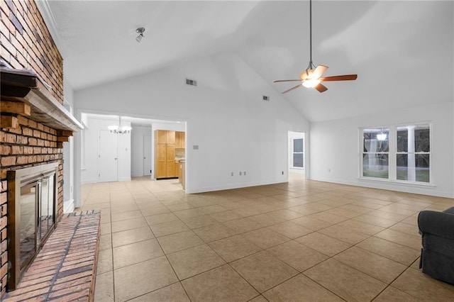 unfurnished living room with a fireplace, high vaulted ceiling, light tile patterned flooring, and ceiling fan with notable chandelier