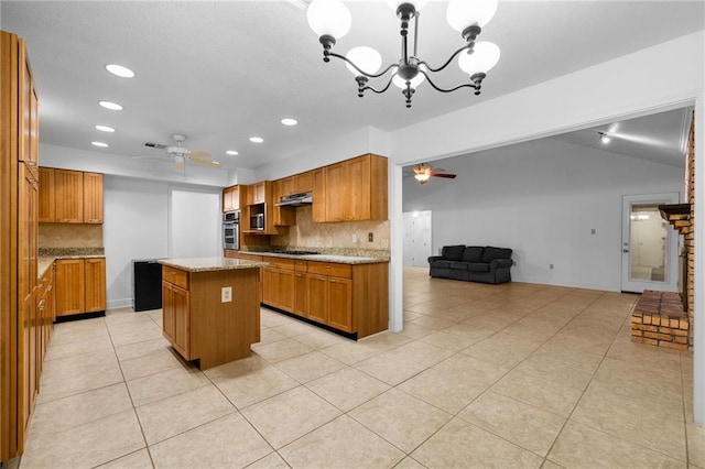 kitchen featuring pendant lighting, ceiling fan with notable chandelier, a kitchen island, and tasteful backsplash