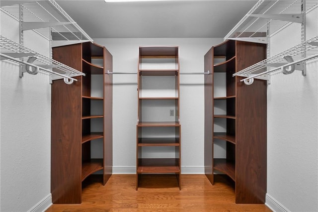 walk in closet featuring hardwood / wood-style flooring