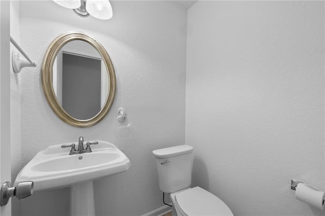 bathroom featuring sink and toilet