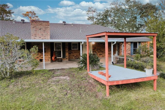 34222 Laurent Rd, Slidell, LA 70460 - back of property with brick siding, a shingled roof, and a yard