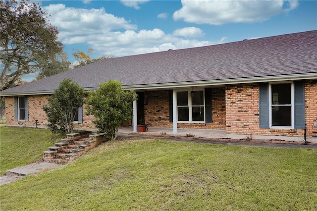 34222 Laurent Rd, Slidell, LA 70460 - ranch-style home with roof with shingles, brick siding, and a front lawn