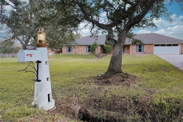 34222 Laurent Rd, Slidell, LA 70460 - view of front of home with an attached garage, a front lawn, and driveway