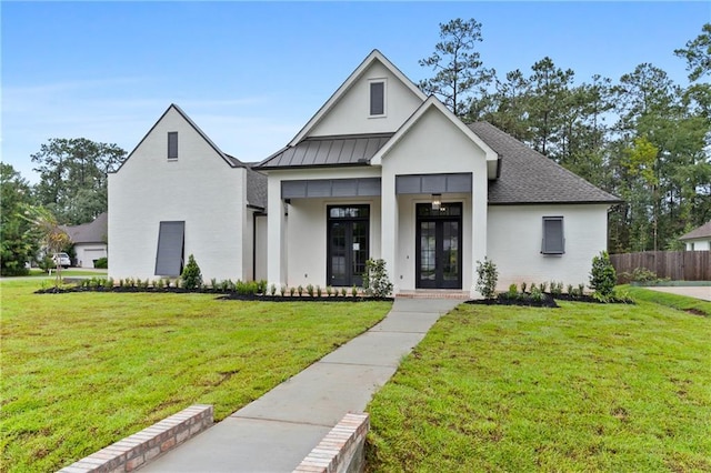 modern farmhouse style home featuring french doors and a front lawn