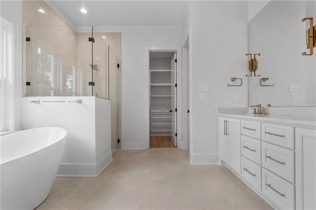 bathroom featuring plus walk in shower, vanity, and ornamental molding