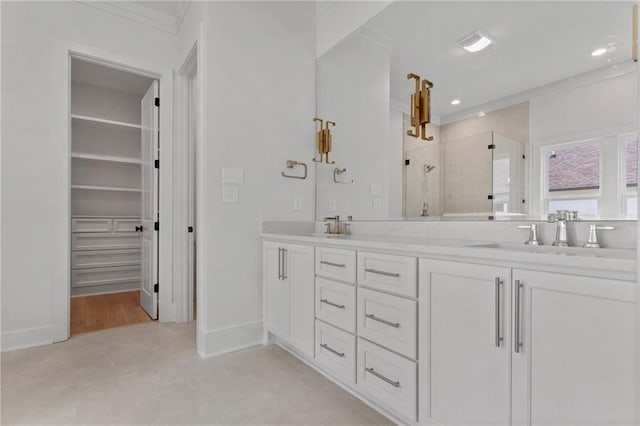 bathroom with vanity, ornamental molding, and walk in shower