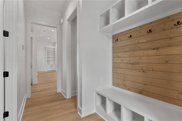 mudroom with light hardwood / wood-style flooring and ornamental molding