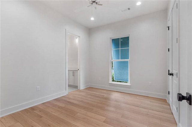 unfurnished room featuring light wood-type flooring and ceiling fan