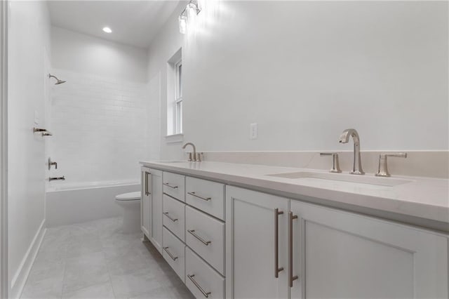 full bathroom with vanity, tiled shower / bath combo, and toilet