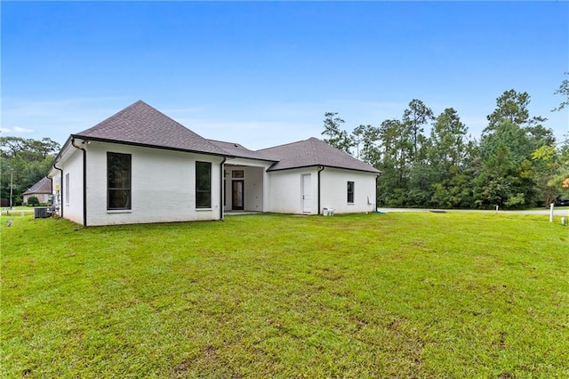 rear view of house with a yard