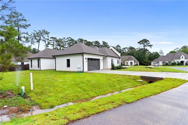 view of front of property with a garage and a front lawn