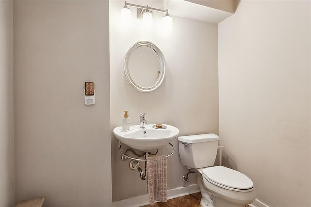 bathroom featuring toilet and sink