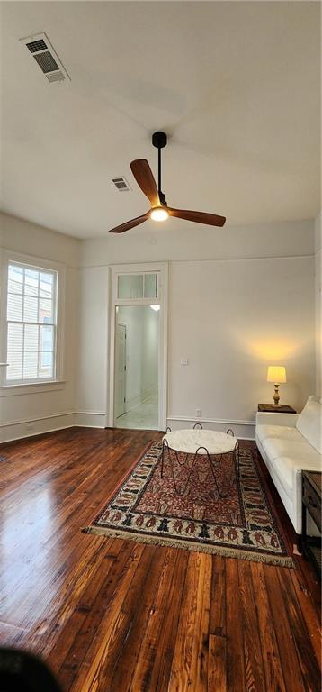 unfurnished room with ceiling fan and wood-type flooring