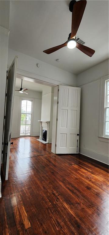 unfurnished living room with dark hardwood / wood-style flooring