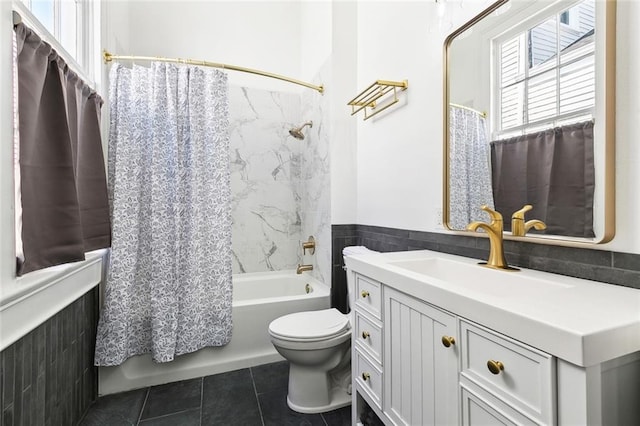 bathroom featuring tile patterned floors, vanity, shower / bathtub combination with curtain, and toilet