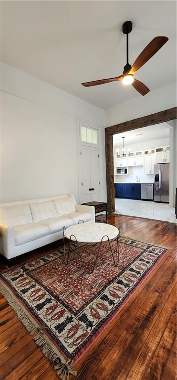 living room featuring hardwood / wood-style flooring and ceiling fan