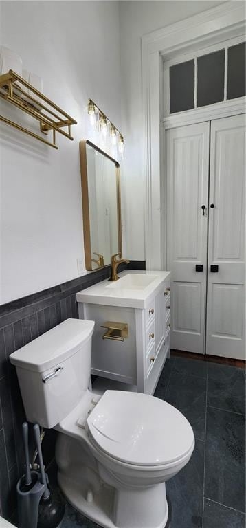 bathroom with tile patterned flooring, vanity, and toilet