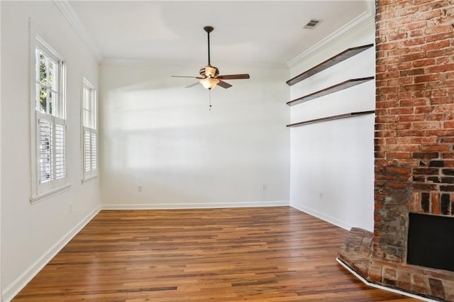 unfurnished living room featuring a fireplace, dark hardwood / wood-style flooring, ceiling fan, and ornamental molding