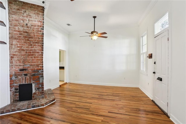 unfurnished living room featuring a fireplace, ceiling fan, hardwood / wood-style floors, and ornamental molding