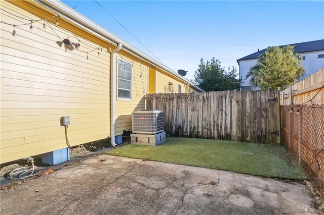 view of yard with cooling unit and a patio