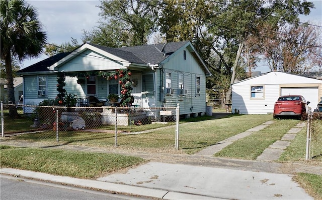 bungalow featuring a porch, a garage, a front lawn, and an outdoor structure