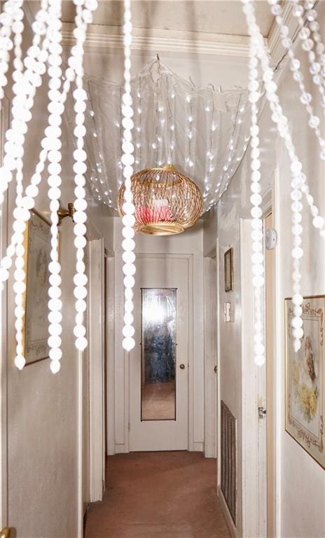 hallway with hardwood / wood-style flooring and crown molding