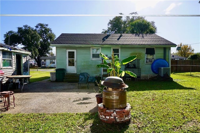 rear view of house with a yard