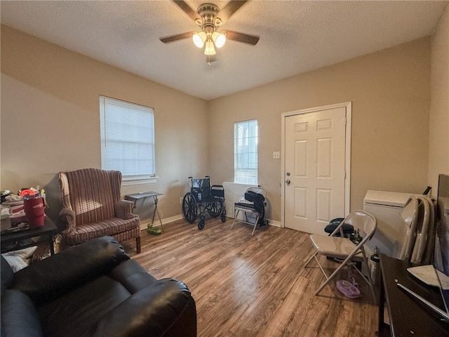 office area featuring hardwood / wood-style flooring, ceiling fan, and a textured ceiling