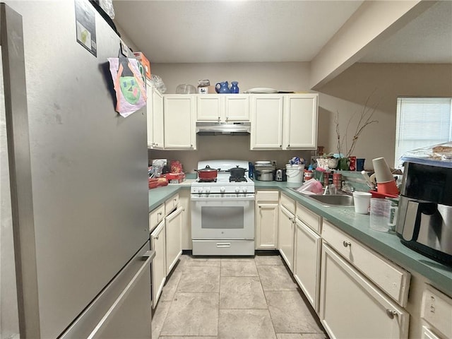 kitchen with light tile patterned flooring, stainless steel fridge, gas range gas stove, and sink