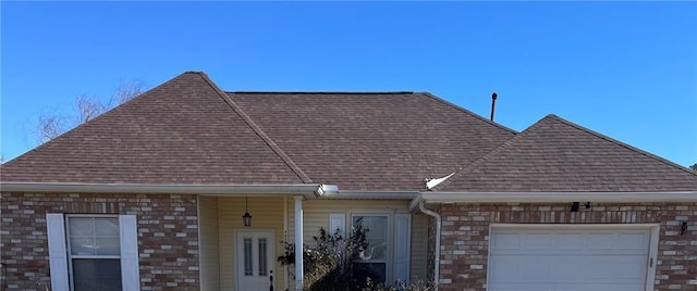 details with gutters, a downspout, and a shingled roof