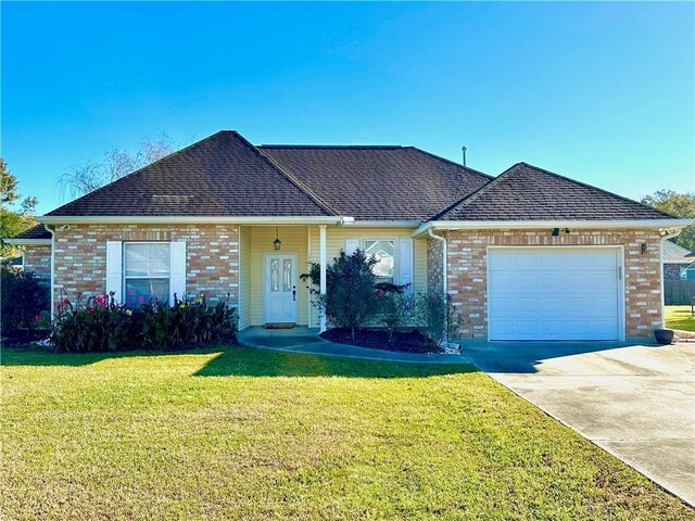 ranch-style home featuring a garage and a front yard