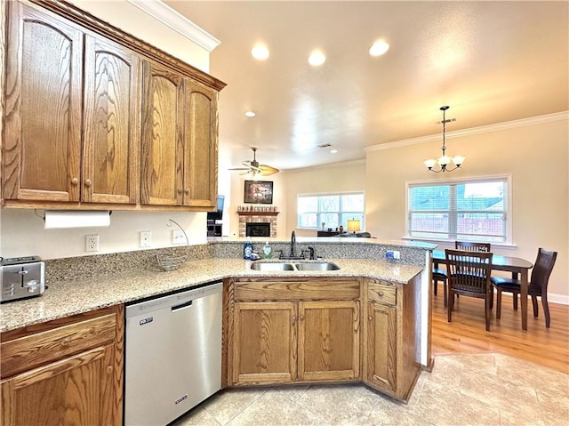 kitchen featuring a peninsula, a sink, dishwasher, crown molding, and brown cabinets