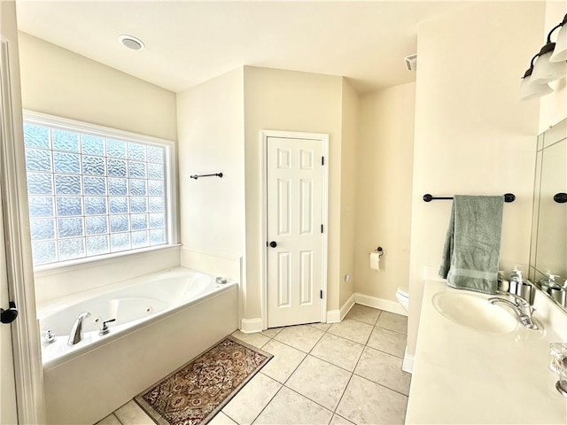 bathroom with vanity, baseboards, tile patterned flooring, a garden tub, and toilet