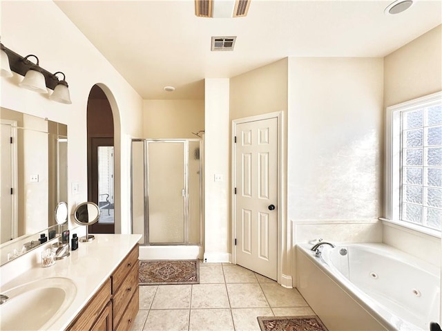 full bathroom with visible vents, a jetted tub, a shower stall, tile patterned flooring, and vanity