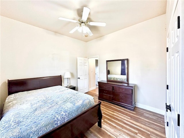 bedroom featuring ceiling fan, baseboards, and wood finished floors