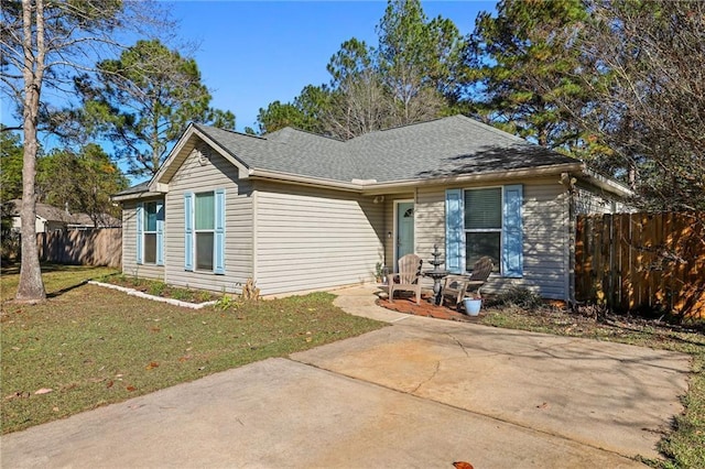 ranch-style home with a patio and a front lawn