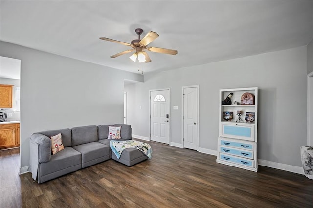 living room featuring dark hardwood / wood-style flooring and ceiling fan